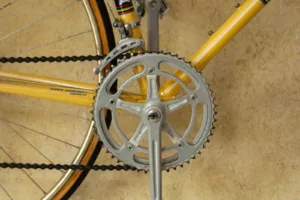 yellow bicycle with grey pedal sprocket