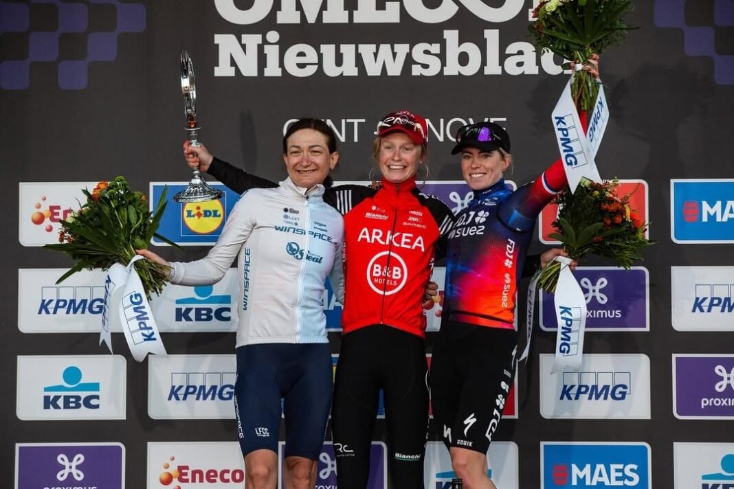 Aurela Nerlo on the podium alongside winner Lotte Claes and third-placed Demi Vollering at the 2025 Omloop Het Nieuwsblad