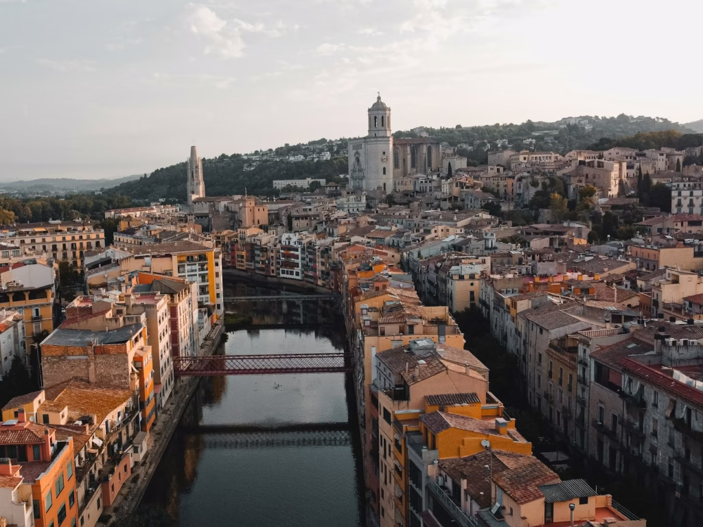 a river running through a city next to tall buildings Girona