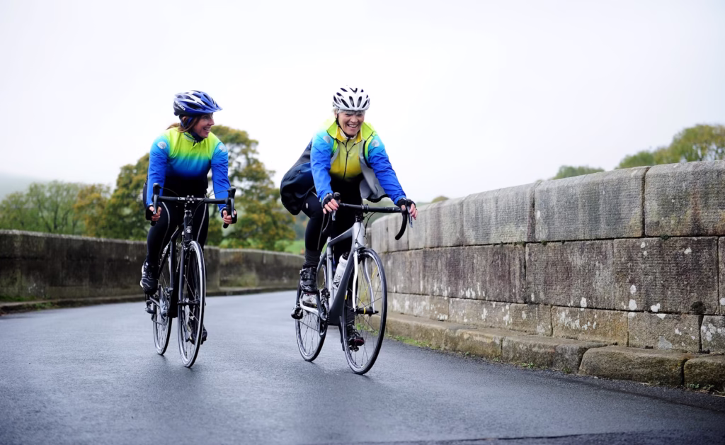 a couple of people riding bikes down a street