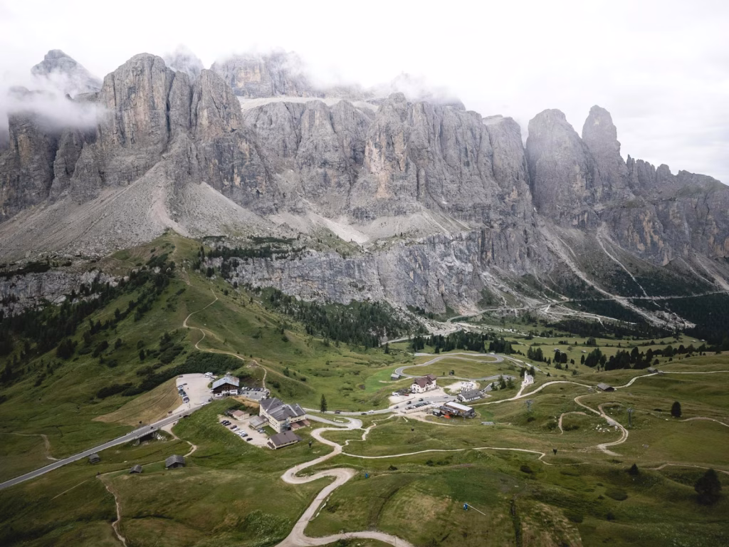 Stunning aerial view of Corvara in the Dolomites, showcasing majestic mountains and lush greenery.