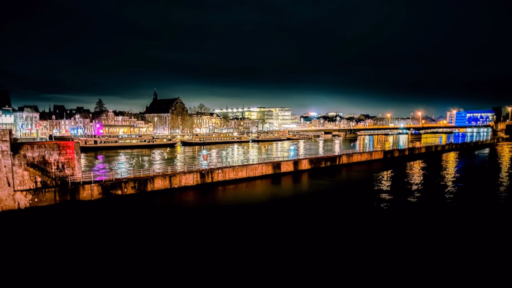 A night time view of a city with a river running through it