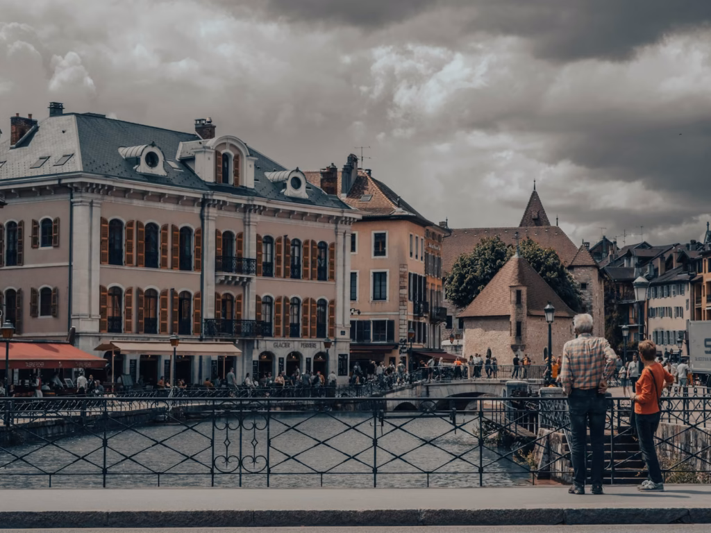a couple of people standing on top of a bridge