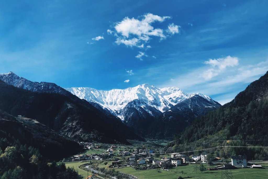 houses near snow covered mountains during daytime