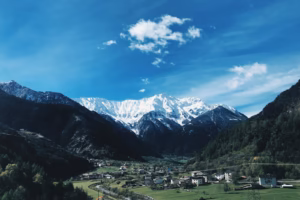 houses near snow covered mountains during daytime