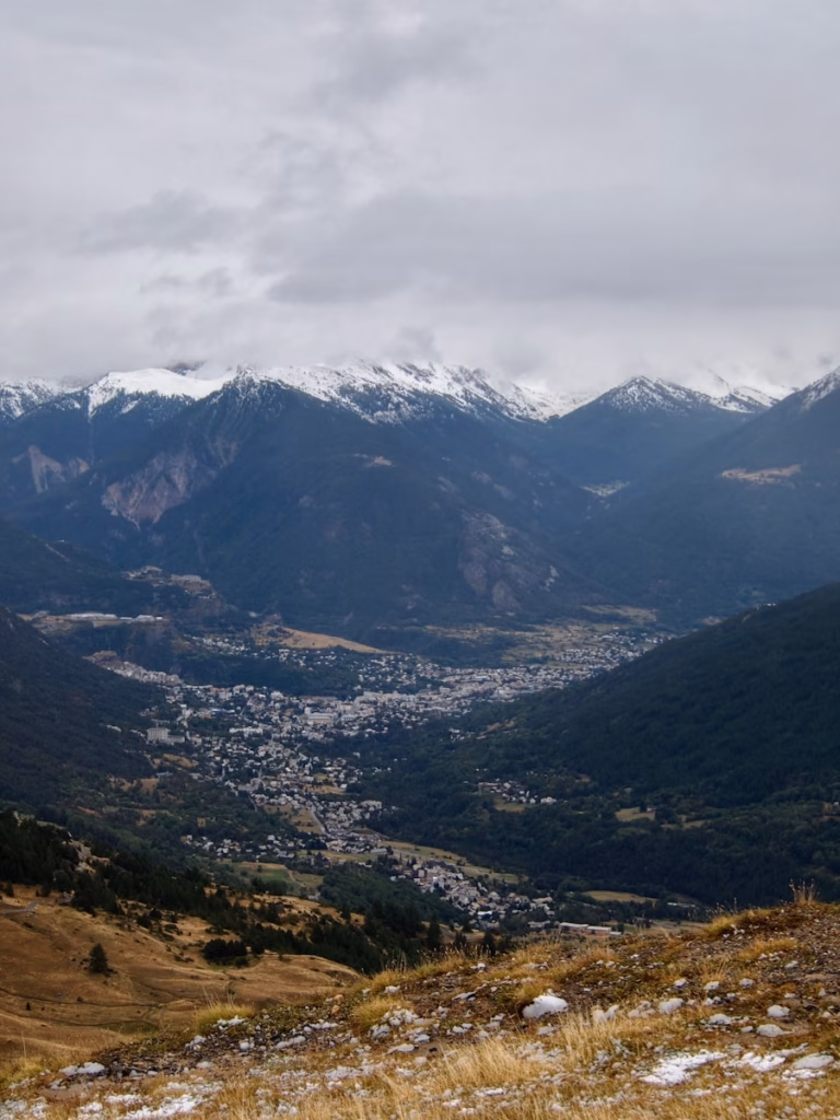 a view of a valley with mountains in the background
