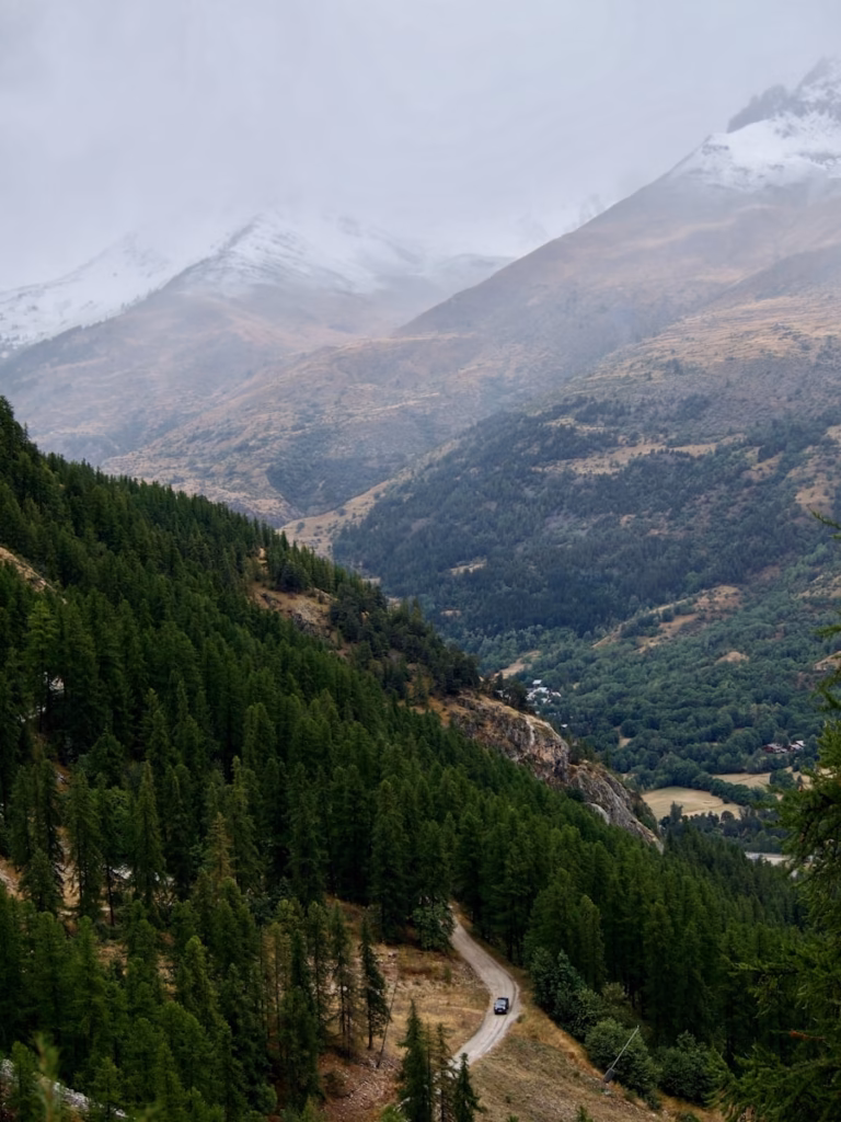 a car driving down a road in the mountains