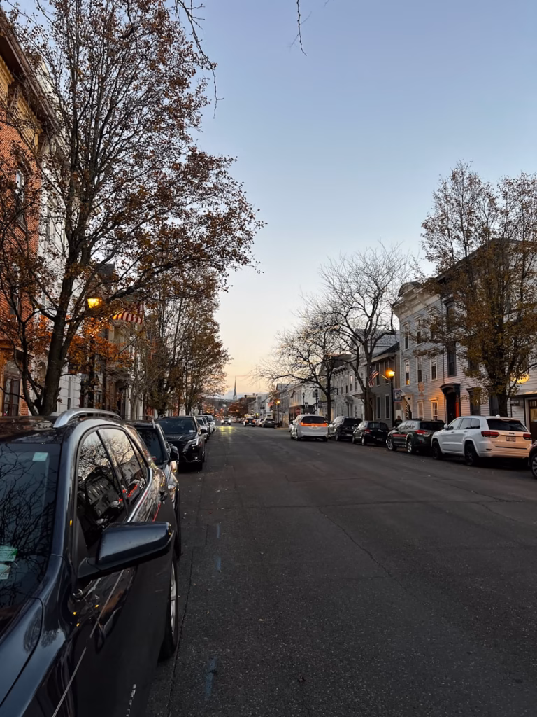 Hudson Valley a street lined with parked cars next to tall buildings