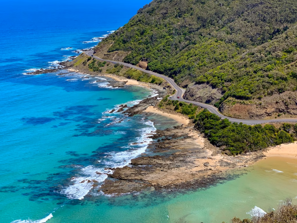 Gold Coast aerial view of green mountain beside blue sea during daytime