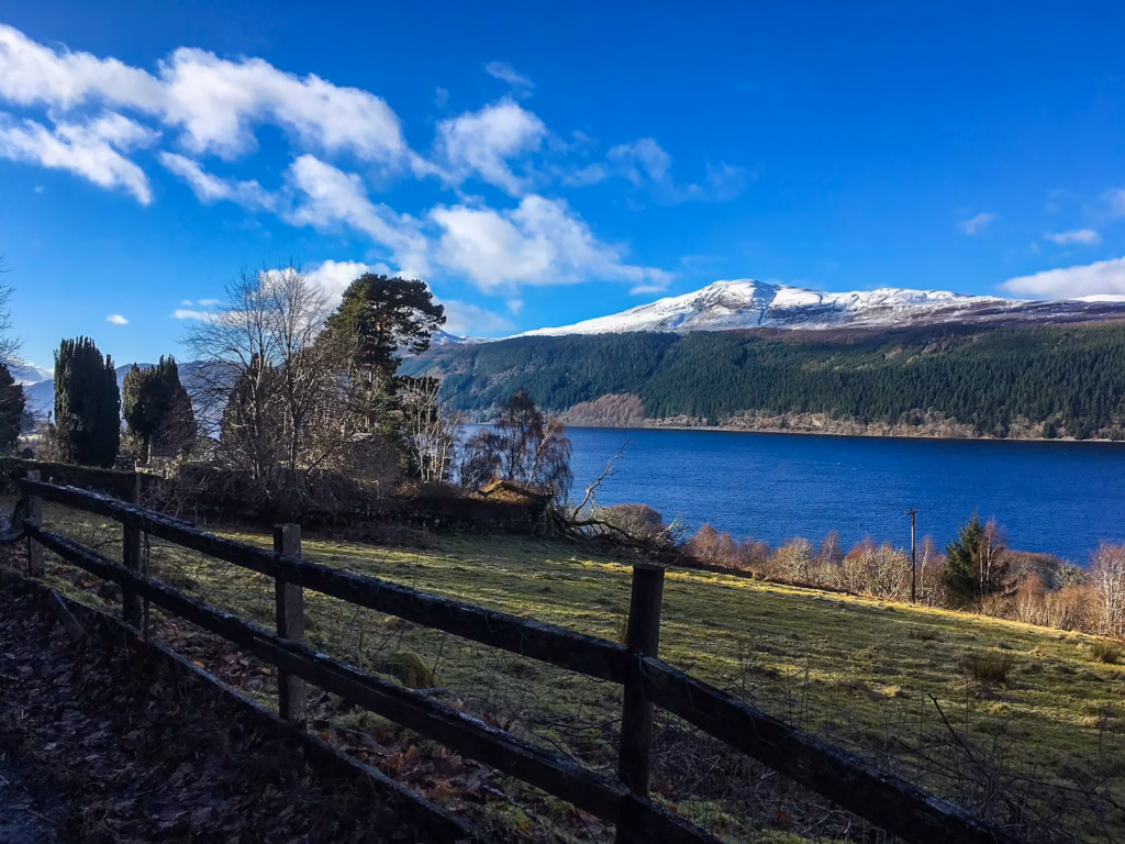 Loch Ness a wooden fence next to a large body of water