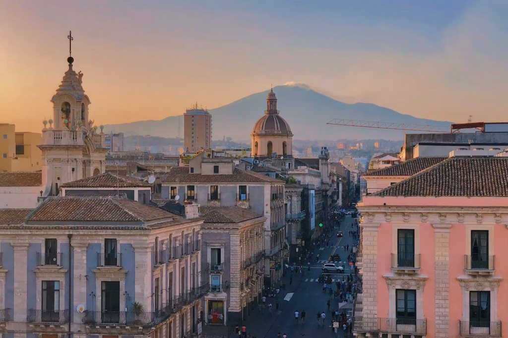 Sicily a view of a city with a mountain in the background