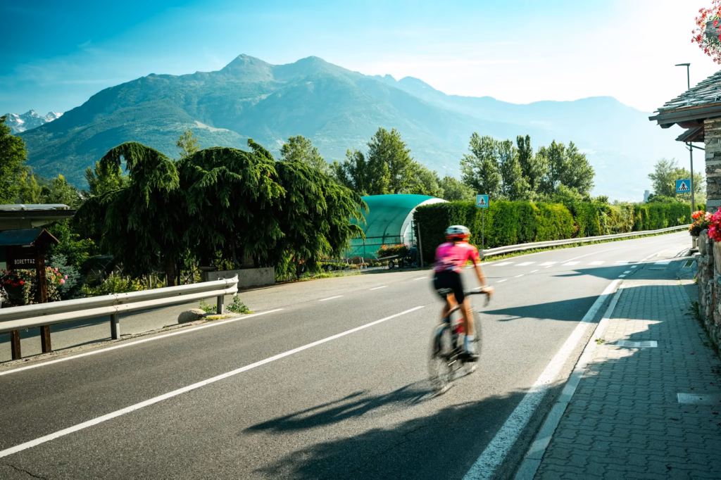 Aosta Valley A person riding a bike down a street