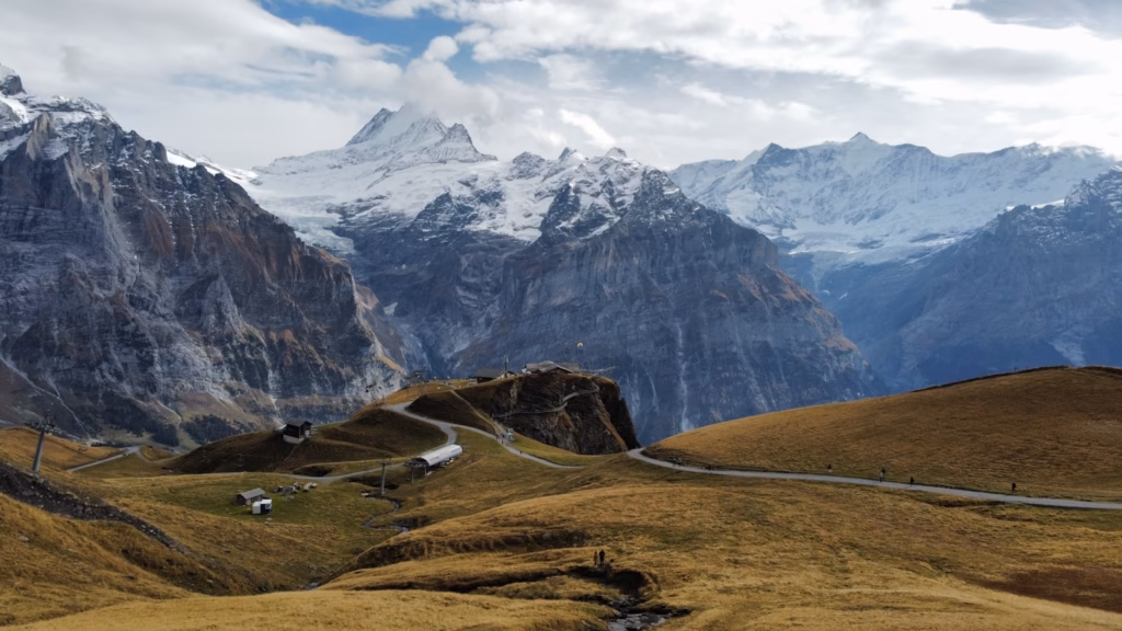 a mountain range with a winding road in the foreground