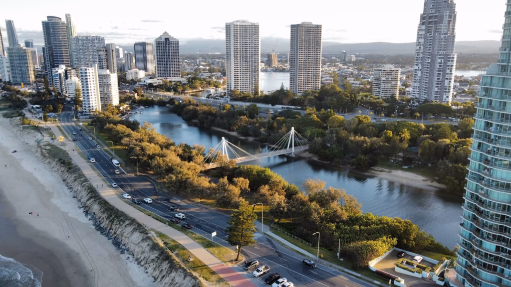Gold Coast a river with a bridge and buildings
