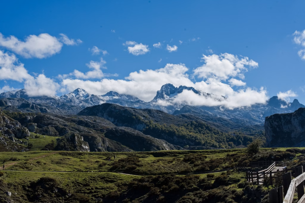a landscape with mountains and clouds