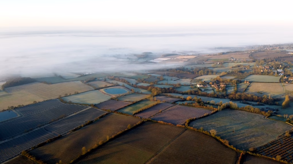 Kent aerial view of green field under cloudy sky during daytime