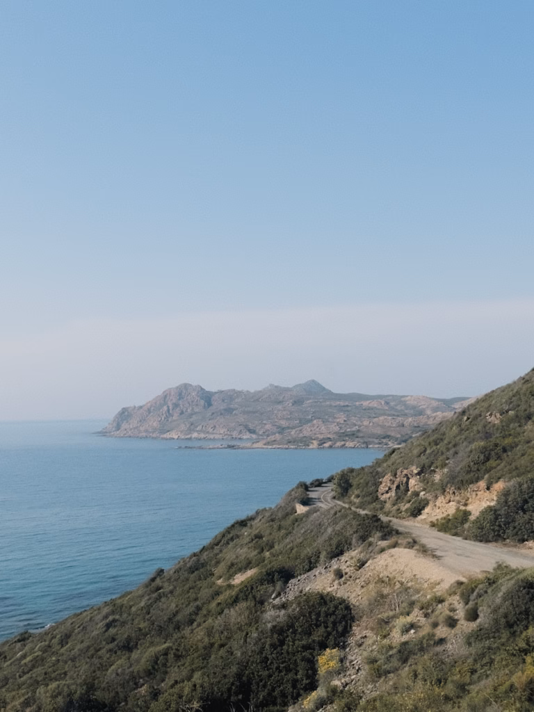 Sardinia a view of the ocean from the top of a hill