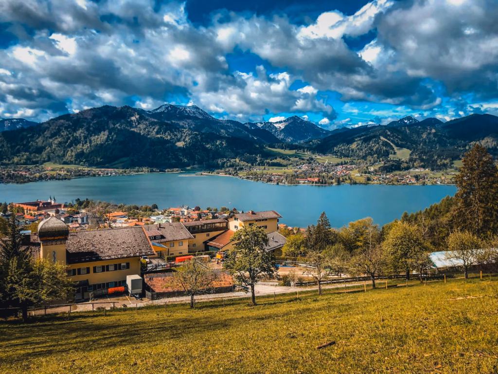 Bavaria Alps brown and white house near lake under blue sky and white clouds during daytime