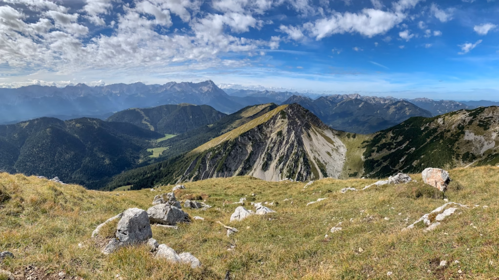 Bavaria Alps a view of a mountain range from a grassy hill