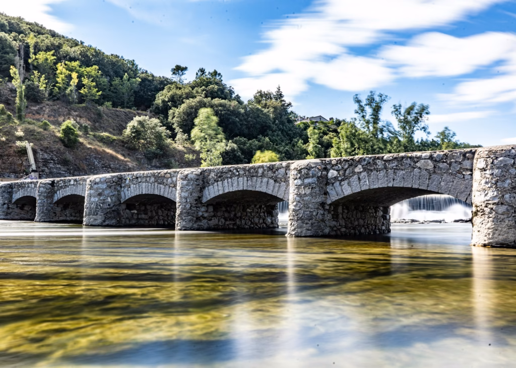 Ardeche France gray concrete bridge over river during daytime