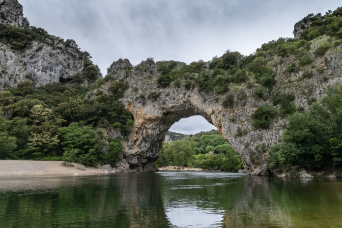 Ardeche France a large body of water with a bridge over it