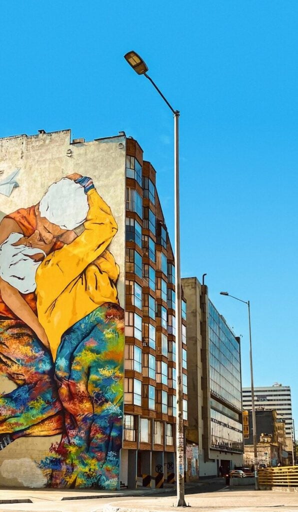 Bogota a large mural of a woman with a yellow jacket