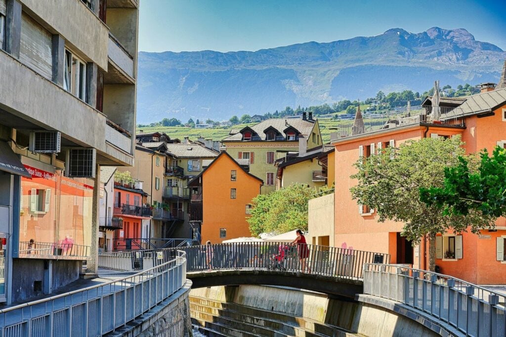 Valais A small bridge over a small river in a city