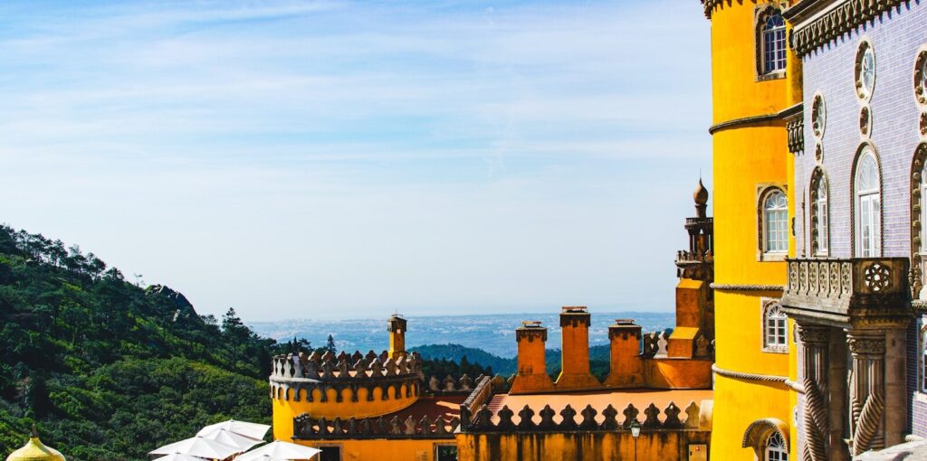 Sintra a large yellow building with a view of the mountains