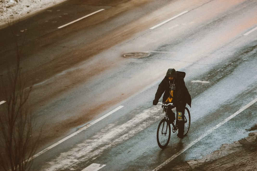 Cyclist riding on a cold road in winter