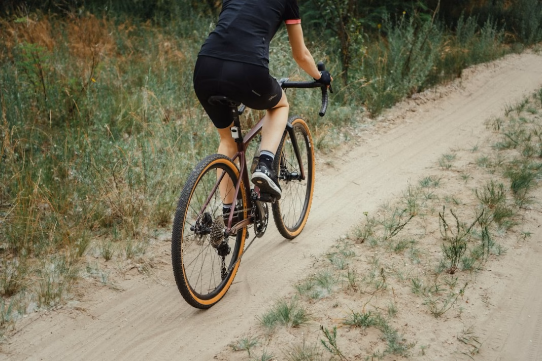 Cyclist riding a gravel bike on rough terrain
