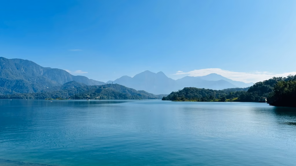 Sun Moon Lake Taiwan A body of water with mountains in the background