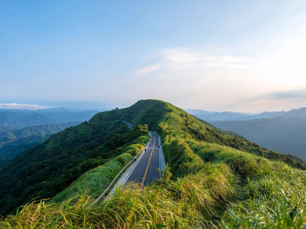 Taiwan green grass field near mountain under white sky during daytime