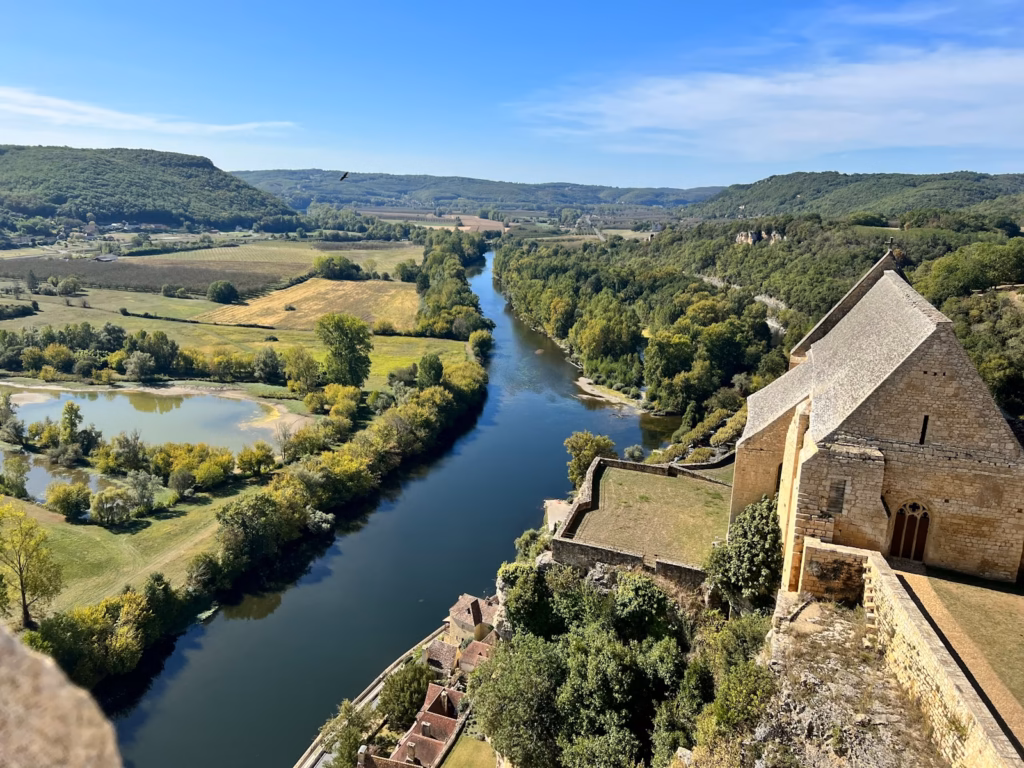 Dordogne Lot Valley a river running through a lush green countryside