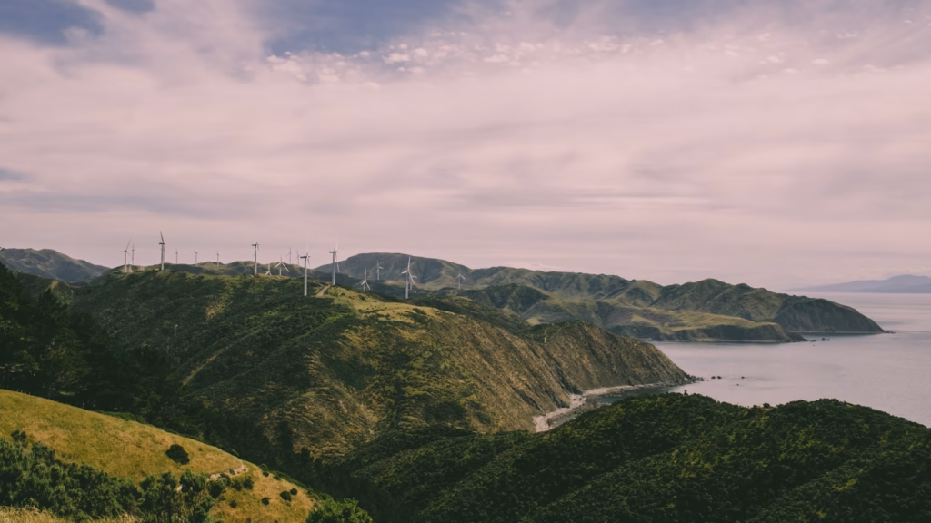 Wellington New Zealand white wind turbines on hill near body of water