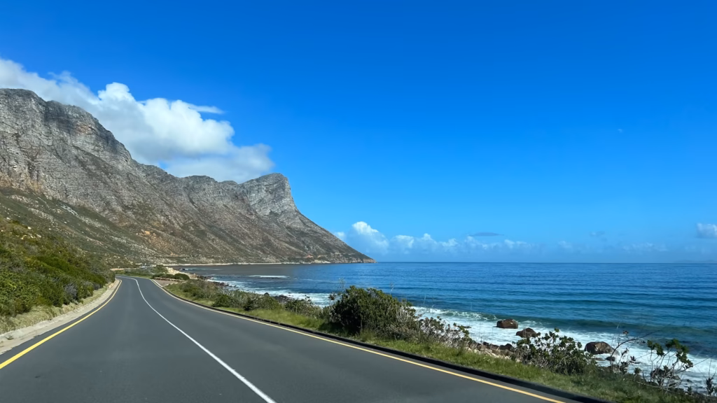 Garden Route South Africa Coastal road with ocean and mountains under blue sky