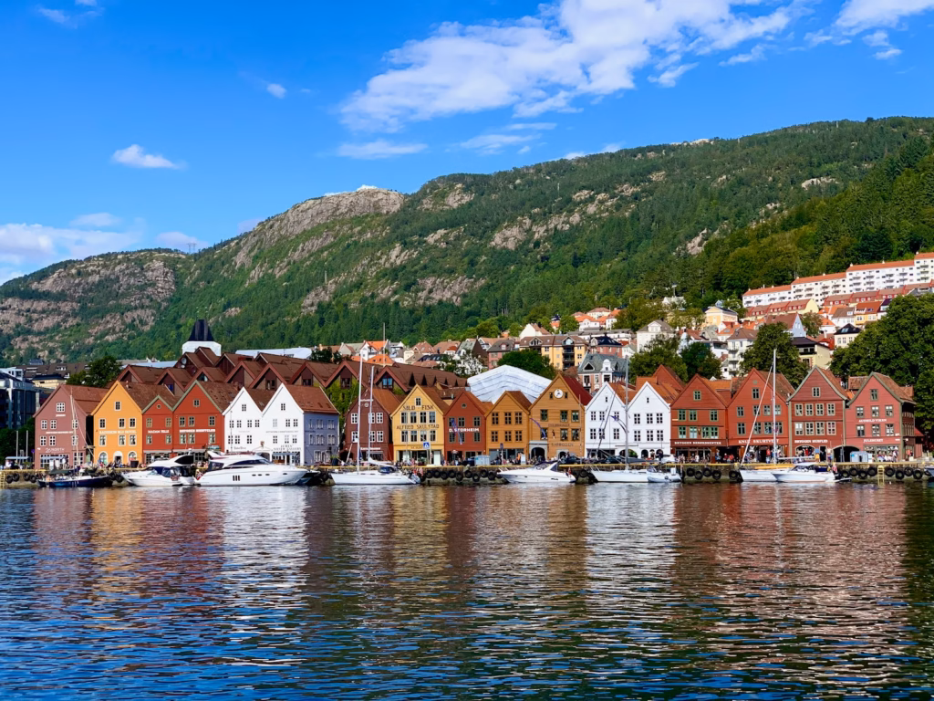 Bergen Norway houses near body of water under blue sky during daytime