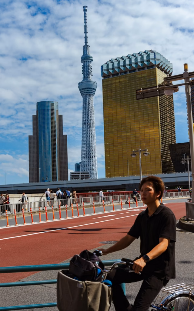 Tokyo Man on bicycle with tokyo skytree in background